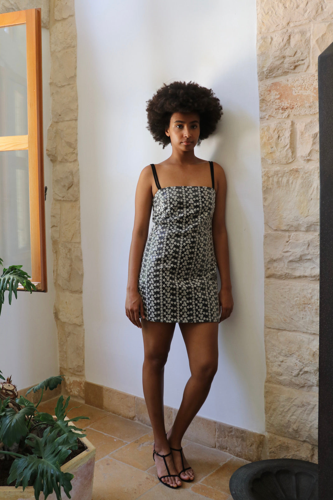 Black denim dress with star sequin embroidery and open V-back detail
