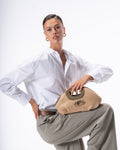 Woman holding a woven handbag against a white background